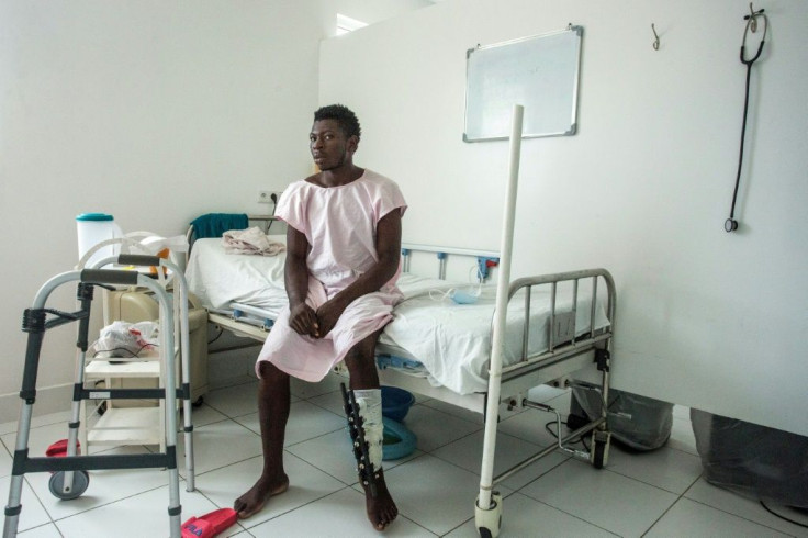 Jonel Cadet, 25, sits in his rehab room at the Doctors Without Borders hospital in Cite Soleil -- if not for his motorcycle accident, he would not have discovered he had COVID-19
