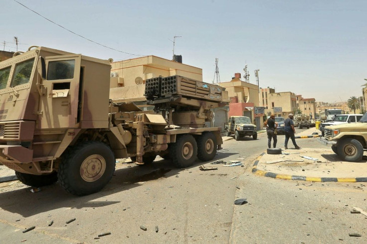 Fighters loyal to Libya's UN-recognised government stand next to a truck-mounted rocket launcher in Tarhuna