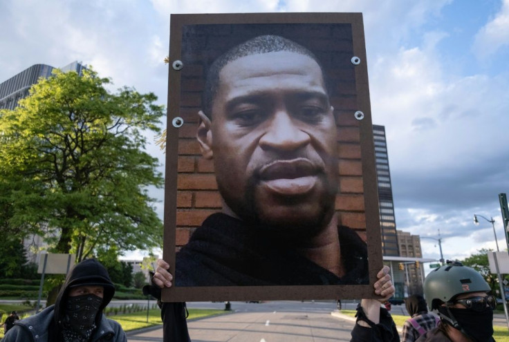 Protesters hold a picture of George Floyd in Detroit, Michigan on May 30, 2020