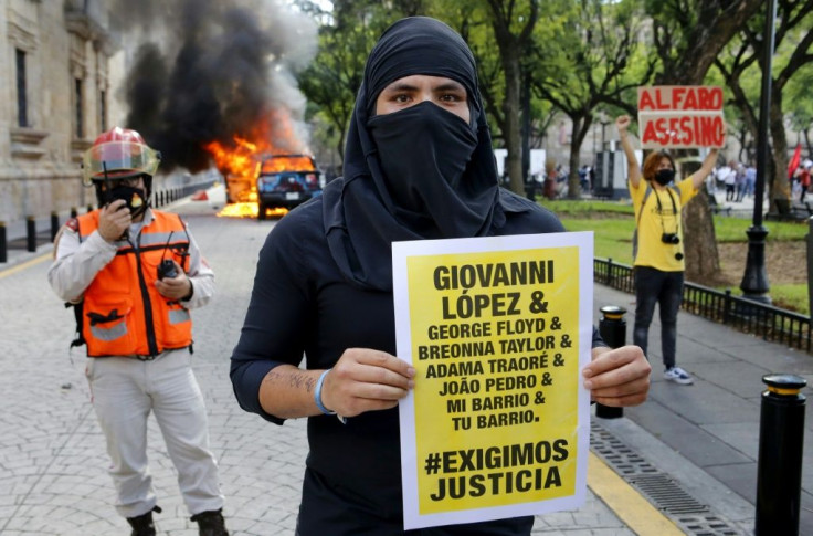 The arrests followed riots in Guadalajara after protesters had gathered to demand justice over Giovanni Lopez's death; a demonstrator holds a banner during a protest in Guadlalajara, Jalisco