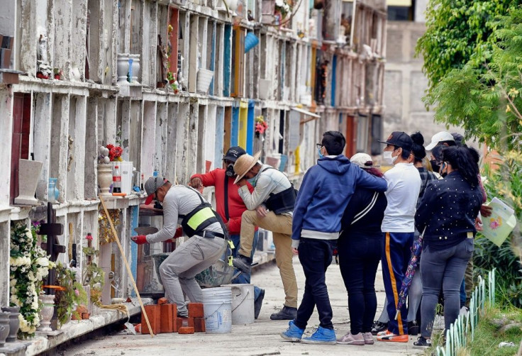Worker Daniel Angeles (L) during an inhumation at the municipal cemetery in Ciudad Nezahualcoyotl