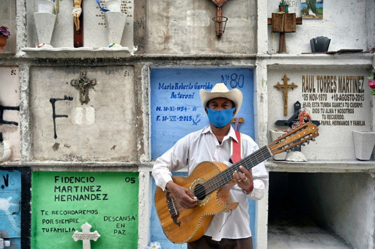Funeral musician Humberto Montes waits to offer his services at Ciudad Nezahualcoyotl's municipal cemetery