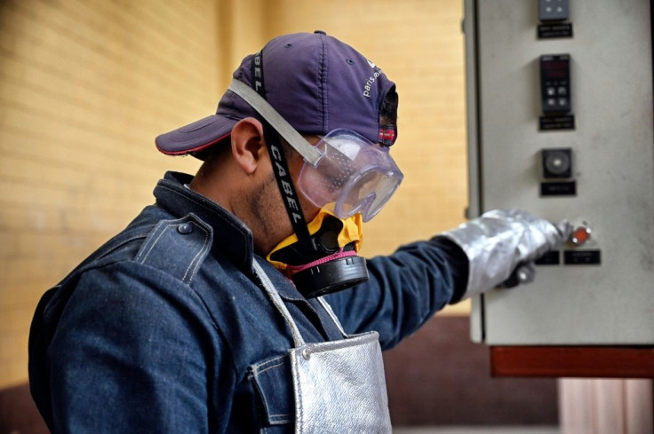 Juan Carlos Cruz fires up the oven at the crematorium