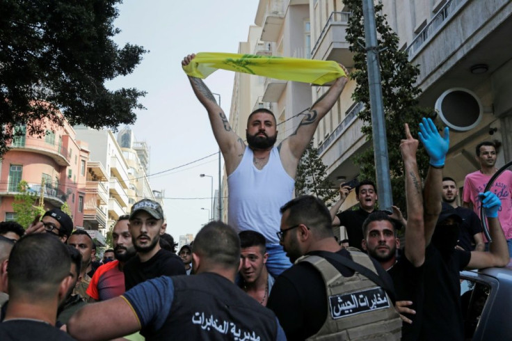 Lebanese army troops form a human chain to separate supporters of Hezbollah from other demonstrators after they clashed during a protest in central Beirut