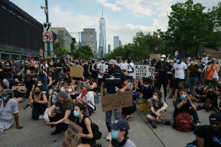 Protesters sit on the road during a peaceful protest against police brutality and racism in New York
