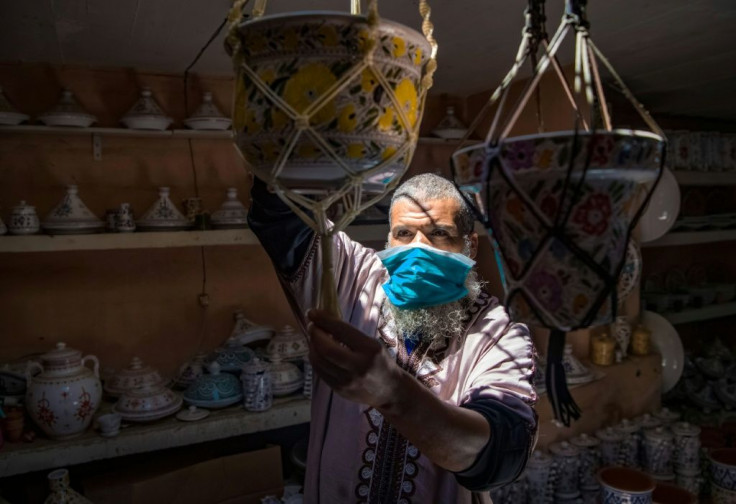 A Moroccan potter displays his handicrafts at a shop in the city of Sale