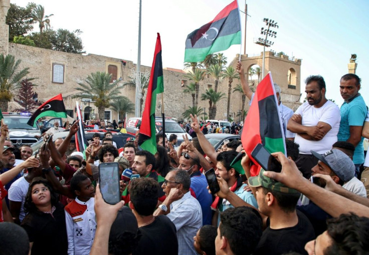 People celebrate in the Libyan capital Tripoli on June 4 after the UN-recognised Government of National Accord (GNA) said it was back in full control of the capital and its suburbs