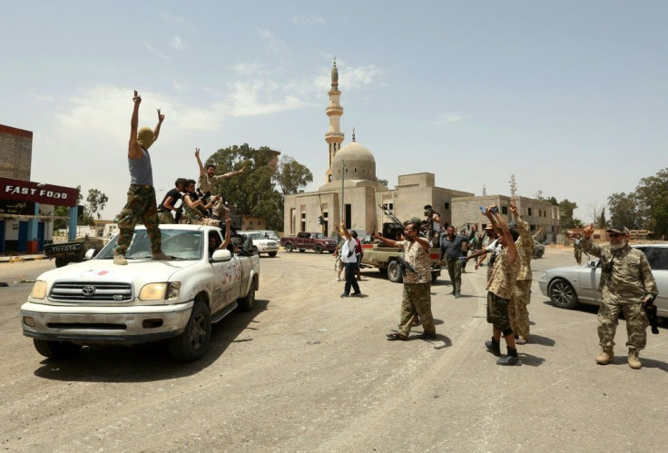 Fighters loyal to the UN-recognised Libyan Government of National Accord (GNA) celebrate victory in the Qasr bin Ghashir district south of the Libyan capital Tripoli on June 4