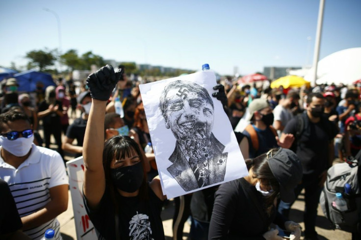 Many protesters against President Jair Bolsonaro in Brasilia were dressed in black and wore face masks