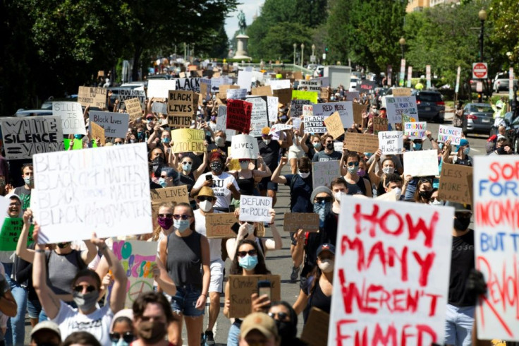 Hundreds of demonstrators walk down 16th Street NW during a rally north of Lafayette Square near the White House to protest police brutality and racism, on June 7, 2020