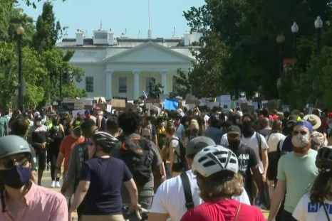 IMAGES Protesters gather peacefully in the afternoon in Washington, DC, to demonstrate peacfully against police brutality. Crowds flock to the White House and walk along the newly-renamed Black Lives Matter Plaza.