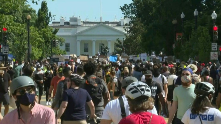 IMAGES Protesters gather peacefully in the afternoon in Washington, DC, to demonstrate peacfully against police brutality. Crowds flock to the White House and walk along the newly-renamed Black Lives Matter Plaza.