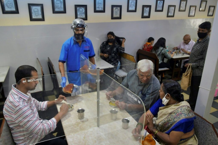 Customers in Bangalore restaurants sat at tables divided by screens