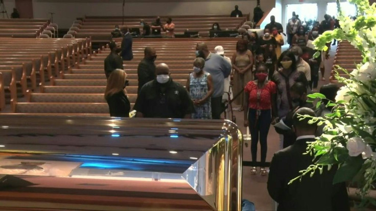 IMAGESMourners arrive at a church in Houston, Texas for a final public memorial to George Floyd before his funeral is held on Tuesday. Floyd was killed in Minneapolis after a white police officer knelt on his neck for nearly nine minutes. His death sparke