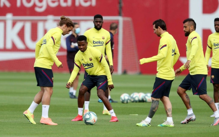 Lionel Messi and Antoine Griezmann take part in a Barcelona training session.