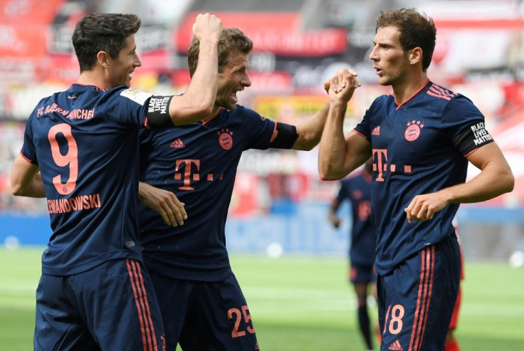 Midfielder Leon Goretzka celebrates with Bayern Munich team-mates Robert Lewandowski (L) and Thomas Mueller in the 4-2 win at Bayer Leverkusen.