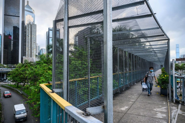 Pedestrian bridges over busy roads are clad in metal cages after protesters distrupted highways by throwing objects from above