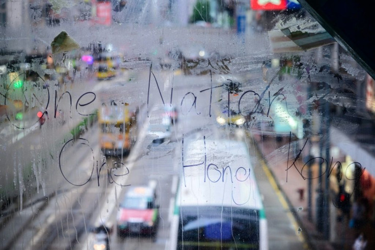 Hong Kong's municipal workers play whack-a-mole with the pro-democracy graffiti that still appears in parts of the city