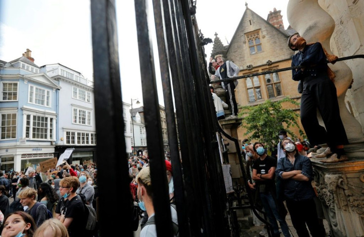 People demand the removal of a statue of British imperialist Cecil Rhodes outside Oxford's Oriel College