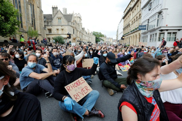 Oxford protesters sat with raised fists for nearly nine minutes in tribute to unarmed black man George Floyd, whose death in US police custody triggered outrage worldwide