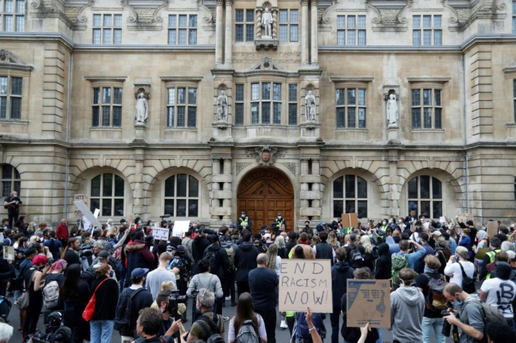Protesters chant "Take it down!" and "Decolonise!", and held placards urging "Rhodes Must Fall" and "Black Lives Matter" in front of the imperialist's statue at Oxford's Oriel College