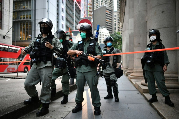 Riot police stand guard ahead of a pro-democracy march in the Central district of Hong Kong