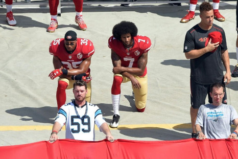 Colin Kaepernick (right) kneels during his protests in 2016. Players and activists are calling for him to be given the chance to rebuild his NFL career