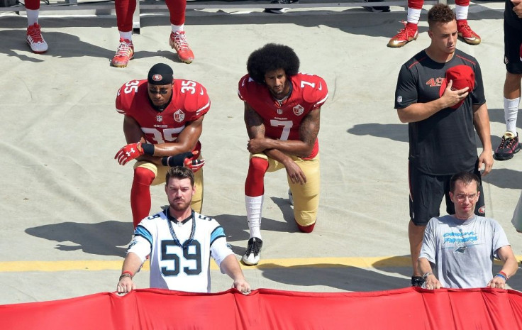 Colin Kaepernick (right) kneels during his protests in 2016. Players and activists are calling for him to be given the chance to rebuild his NFL career