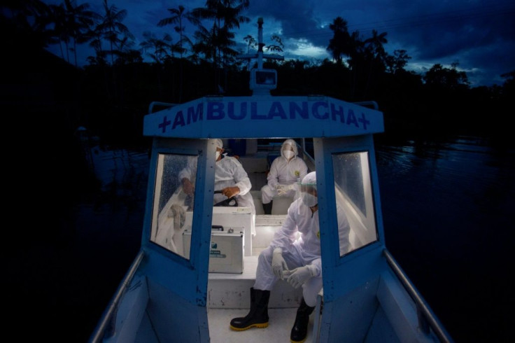 Health workers from the city of Melgaco ride a boat ambulance after visiting a small riverside community on Marajo Island, state of Para, Brazil