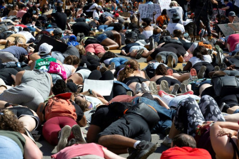 Hundreds of demonstrators lie on the pavement during a rally north of Lafayette Square near the White House to protest police brutality and racism on June 7, 2020