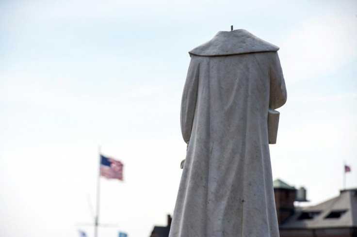 A decapitated statue of Columbus is seen at Christopher Columbus Park in Boston, Massachusetts on June 10