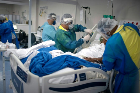 Health professionals check a patient infected with COVID-19 at the Intensive Care Unit (ICU) of the Doctor Ernesto Che Guevara Public Hospital in Marica, Rio de Janeiro state, Brazil, on June 6, 2020