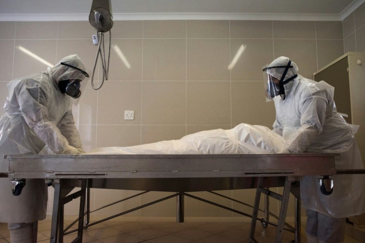 Members of a Muslim burial organisation prepare the body of a man who died of COVID-19 coronavirus at the Ghietmatiel Islamia Mosque in Athlone, Cape Town