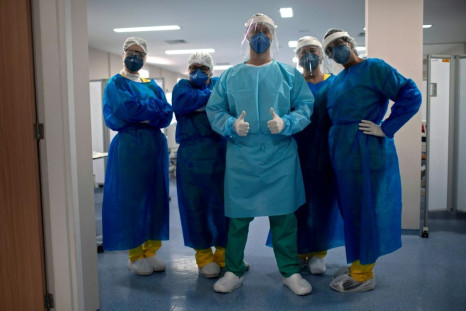 A team of nurses stand in the Intensive Care Unit of the Doctor Ernesto Che Guevara Public Hospital, where patients infected with COVID-19 are being treated, in Marica, Rio de Janeiro state, Brazil