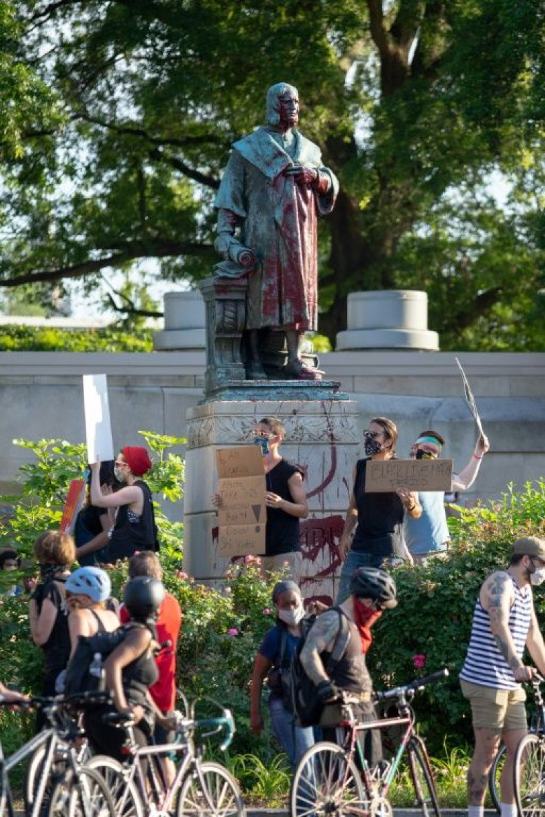 Protesters surround a statue of Christopher Columbus in Richmond, Virginia, before  pulling it down