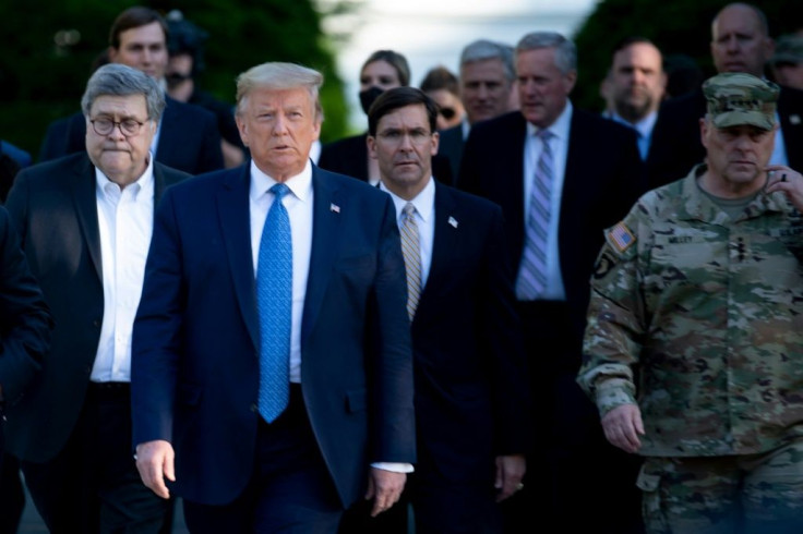 Donald Trump walks with Joint Chiefs Chairman General Mark Milley (R) at his side and Defense Secretary Mark Esper (middle) just behind him on June 1 to a church near the White House where Trump posed for pictures