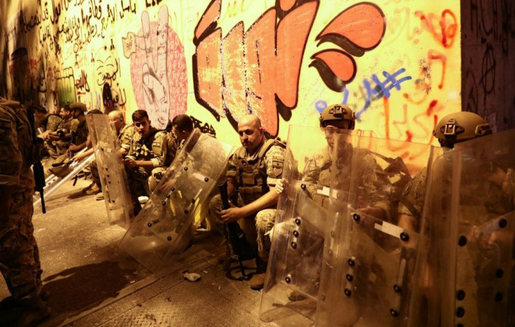 Lebanese soldiers rest during a lull at a demonstration in Beirut against dire economic conditions in Lebanon