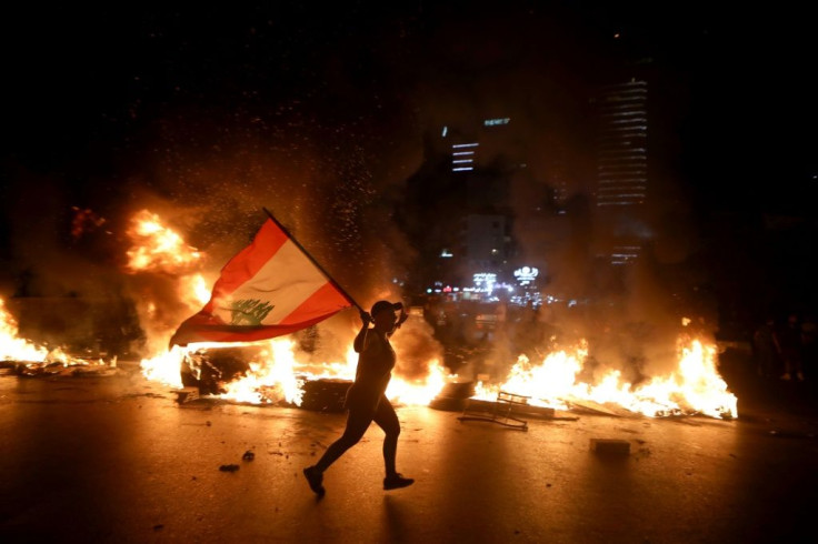 Lebanese protesters angered by a growing economic crisis set tyres on fire and blocked roads