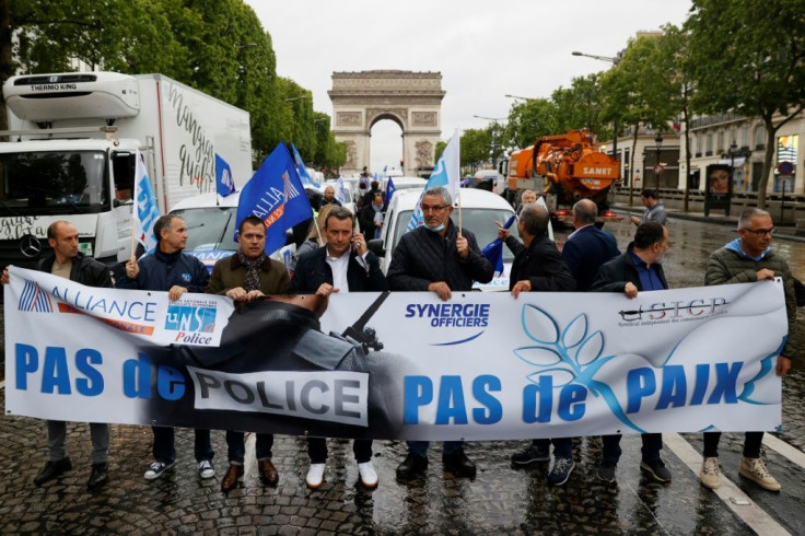 Several dozen police blocked traffic in a wildcat march down the Champs-Elysees avenue in Paris, carrying a banner proclaiming: "No police, no peace!"