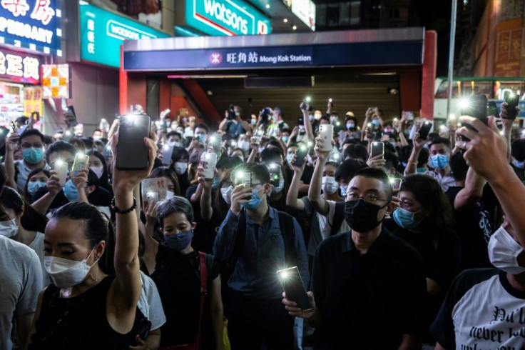 Protesters light up their mobile phones while chanting slogans and singing songs to mark the one year anniversary of major clashes between  police and pro-democracy demonstrators