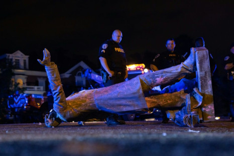 A statue of Confederate President Jefferson Davis lies in the street after protesters pulled it down in Richmond, Virginia