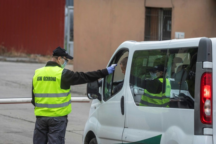 A security worker checks the temperature of a van driver arriving at the Ruch Zofiowka coal mineat Jastrzebie Zdroj, southern Poland