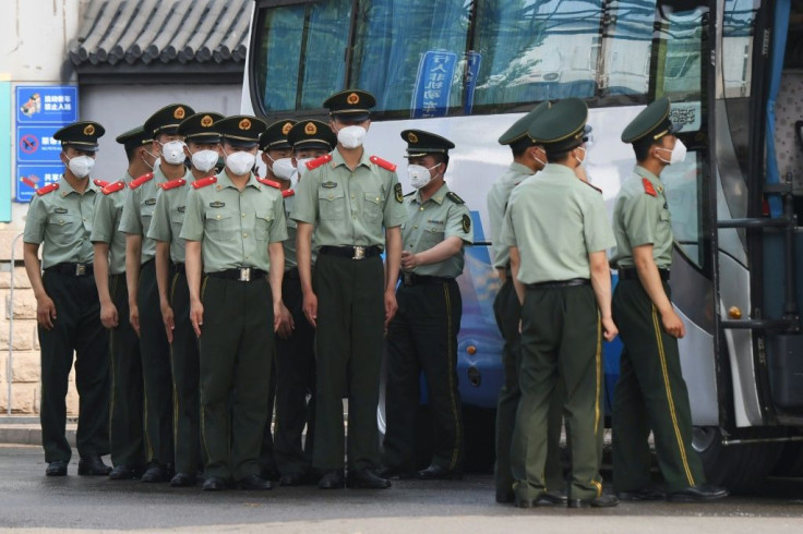 Chinese paramilitary police guard entrances to Beijing's now closed Xinfadi market