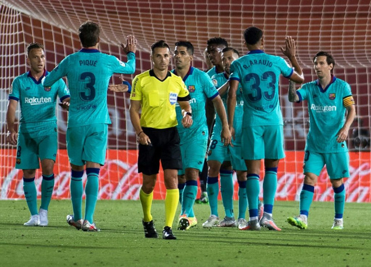 Lionel Messi (R) celebrates with his Barcelona teammates after scoring the final goal in their 4-0 win at Mallorca on Saturday