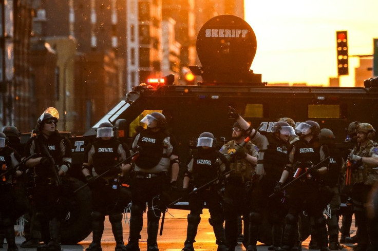 Minnesota State Police officers in front of an armored sheriff's vehicle on May 31, 2020 in Minneapolis, during a protest against police brutality after the killing of George Floyd days earlier
