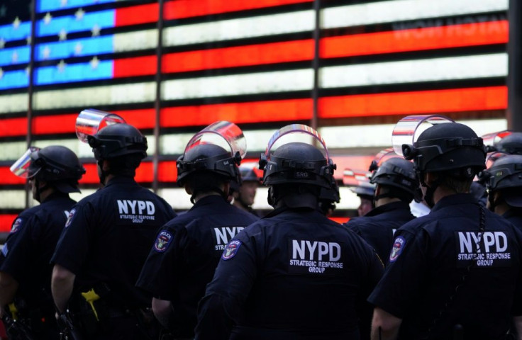 NYPD police officers watch demonstrators in Times Square on June 1 during a Black Lives Matter protest