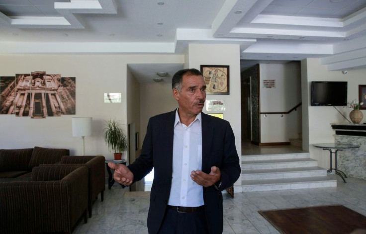 Tarik Twissi stands in the empty lobby of his hotel La Maison in Petra where reservations were at 90 percent before the coronavirus pandemic forced visitors to cancel