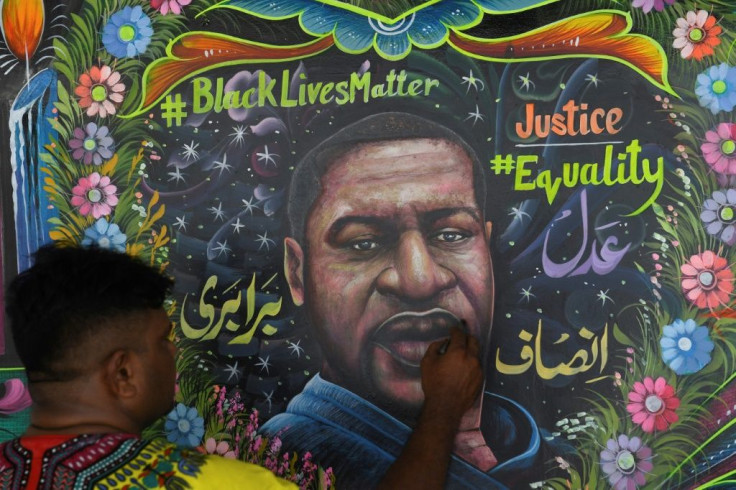 A Pakistani artist puts the final touches on a mural of George Floyd, the African American whose killing by a white police officer has ignited protests against racism around the world