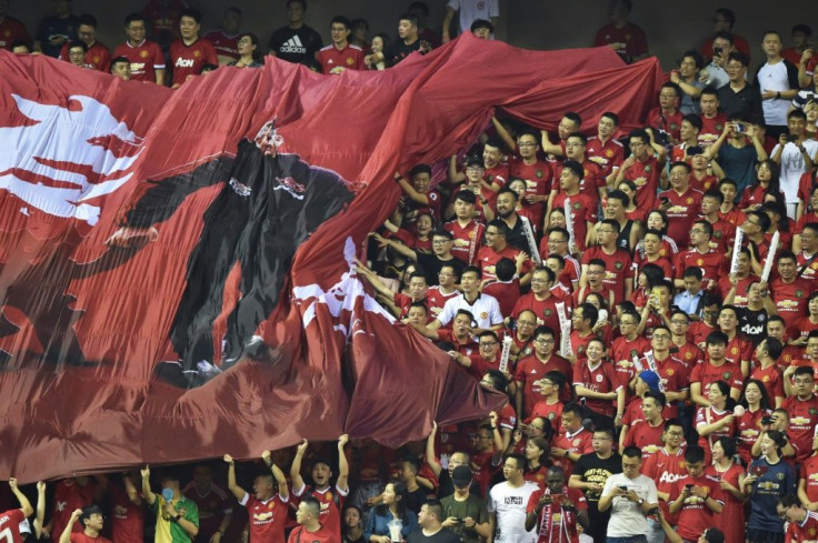 Manchester United fans attend a friendly against Tottenham in Shanghai in July 2019