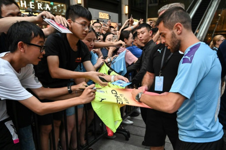 In demand: Manchester City midfielder Bernardo Silva signs autographs in Shanghai